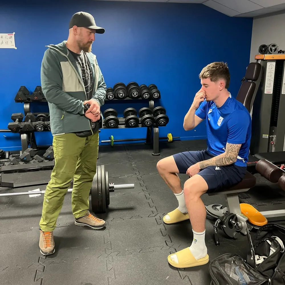 Maciej Szyszka running a breathing test with a Lech Poznań player